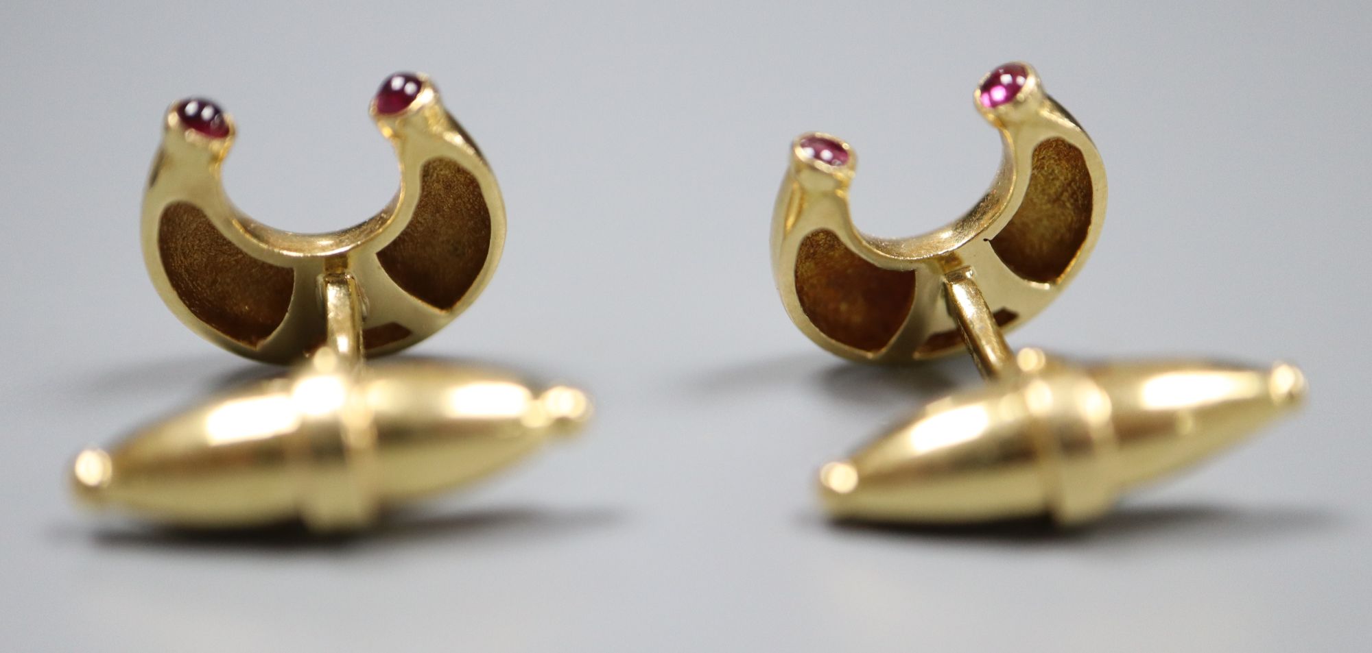 A pair of modern 18ct gold and ruby set horseshoe shaped cufflinks by Mappin & Webb